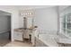 Bathroom showcasing granite countertops, white cabinets, and a soaking tub with stone surround at 2167 Merrymount Dr, Suwanee, GA 30024