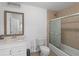 Well-lit bathroom featuring a framed mirror, vanity, toilet, and a glass-enclosed shower at 2167 Merrymount Dr, Suwanee, GA 30024