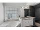 Bathroom showcasing a white soaking tub, granite counters, and a stylish tiled shower at 2167 Merrymount Dr, Suwanee, GA 30024