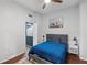 Cozy bedroom with hardwood floors, a comfortable bed, and contemporary decor at 2167 Merrymount Dr, Suwanee, GA 30024