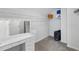 Walk-in closet featuring a vanity area with Hollywood mirror and ample shelving for storage at 2167 Merrymount Dr, Suwanee, GA 30024