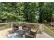 Back deck area with outdoor furniture and a blue patterned rug at 2167 Merrymount Dr, Suwanee, GA 30024