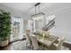 Bright dining room featuring large windows, hardwood floors, and an elegant chandelier at 2167 Merrymount Dr, Suwanee, GA 30024