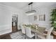 Elegant dining room with modern chandelier, neutral paint, and view of kitchen at 2167 Merrymount Dr, Suwanee, GA 30024