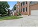 The exterior of this brick home features a well-maintained lawn, brick steps, and a side-entry garage at 2167 Merrymount Dr, Suwanee, GA 30024