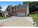 Brick facade, two story home featuring a two car garage, and a large driveway at 2167 Merrymount Dr, Suwanee, GA 30024