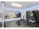 Home gym with padded floors, weightlifting equipment, full mirror and accent lighting at 2167 Merrymount Dr, Suwanee, GA 30024