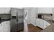 Kitchen showcasing stainless steel refrigerator, granite counters, and white cabinets at 2167 Merrymount Dr, Suwanee, GA 30024