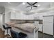 Bright kitchen features white cabinets, a peninsula, and modern appliances at 2167 Merrymount Dr, Suwanee, GA 30024