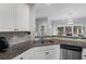 A beautifully designed kitchen featuring a stainless steel sink, granite countertops, and stylish backsplash at 2167 Merrymount Dr, Suwanee, GA 30024