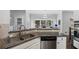 Eat-in kitchen features stainless appliances, granite counters, and a great view to the yard at 2167 Merrymount Dr, Suwanee, GA 30024