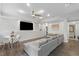 Spacious living room with a large sectional sofa, modern decor, and an adjacent dining area at 2167 Merrymount Dr, Suwanee, GA 30024
