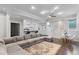 Open-concept living room with a sectional sofa, dining area, and bar seating at the kitchen counter at 2167 Merrymount Dr, Suwanee, GA 30024