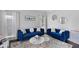 Stylish living room featuring hardwood floors, two blue sofas, and decorative accents at 2167 Merrymount Dr, Suwanee, GA 30024