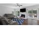 Cozy living room with hardwood floors, a fireplace, and plenty of natural light from the windows at 2167 Merrymount Dr, Suwanee, GA 30024