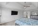 Main bedroom featuring tray ceilings and a mounted television at 2167 Merrymount Dr, Suwanee, GA 30024