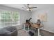 Bright home office with large window and adjustable standing desk at 2167 Merrymount Dr, Suwanee, GA 30024