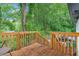 Exterior view of wood deck overlooking a lush backyard with mature trees at 2266 Kennedy Nw Ct, Atlanta, GA 30318