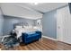 Cozy bedroom with a comfy bed, stylish furniture, and wood-look laminate flooring at 2266 Kennedy Nw Ct, Atlanta, GA 30318