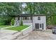 Charming home with a black and white exterior, a welcoming porch, and a landscaped yard at 2266 Kennedy Nw Ct, Atlanta, GA 30318