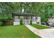 Charming renovated home with a covered front porch, lush lawn, and painted brick facade at 2266 Kennedy Nw Ct, Atlanta, GA 30318