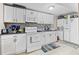 Efficient kitchen features white appliances and ample counter space with stacked washer and dryer at 2266 Kennedy Nw Ct, Atlanta, GA 30318