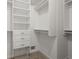 Walk-in closet with white shelving, drawers, and wire basket for organized storage at 4085 Tritt Homestead Dr, Marietta, GA 30062