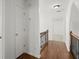 Hallway with wood floors and iron railings leading to a bedroom at 4085 Tritt Homestead Dr, Marietta, GA 30062