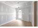 A bright bedroom showcasing new flooring and a unique arched window, awaiting your personal touch at 6010 Fieldcrest Dr, Morrow, GA 30260
