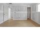 Large bedroom showcases newly installed floors, primed walls, and multiple doors at 6010 Fieldcrest Dr, Morrow, GA 30260