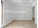 Well-lit bedroom with modern wood flooring, fresh primed walls, and a classic white door at 6010 Fieldcrest Dr, Morrow, GA 30260
