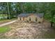 Lovely single-story brick home nestled among mature trees and a front yard at 6010 Fieldcrest Dr, Morrow, GA 30260
