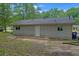 Rear exterior with new siding and windows, awaiting landscaping and final touches at 6010 Fieldcrest Dr, Morrow, GA 30260