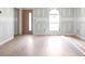 Spacious living room with new wood flooring and an arched window at 6010 Fieldcrest Dr, Morrow, GA 30260