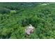 Aerial view of a secluded home surrounded by lush green trees providing privacy at 6020 Cochran Mill Rd, Palmetto, GA 30268