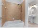 Bathroom featuring a tub/shower with tan tiling and a pedestal sink at 6020 Cochran Mill Rd, Palmetto, GA 30268