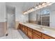 Bathroom with a long vanity with double sinks, a large mirror, and a tiled shower at 6020 Cochran Mill Rd, Palmetto, GA 30268