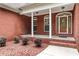 Charming brick porch with columns and manicured landscaping create inviting curb appeal at 6020 Cochran Mill Rd, Palmetto, GA 30268