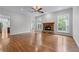 Bright living room featuring hardwood floors, a fireplace, and large windows with natural light at 6020 Cochran Mill Rd, Palmetto, GA 30268