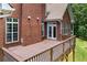 Spacious rear deck off a brick home with view of the backyard and mature trees at 6020 Cochran Mill Rd, Palmetto, GA 30268