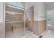 Shower featuring tile surround, bench, and glass door at 6020 Cochran Mill Rd, Palmetto, GA 30268