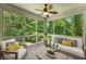 Cozy sunroom offers serene views with wall-to-wall windows and comfortable seating arrangement at 6020 Cochran Mill Rd, Palmetto, GA 30268