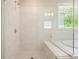 Bathroom featuring a spacious glass shower with marble-patterned tiles and a built-in bench at 622 Denali Dr, Mableton, GA 30126