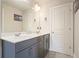 Bathroom featuring double sinks, modern fixtures, and gray tiling, offering a clean and stylish design at 622 Denali Dr, Mableton, GA 30126