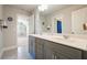 Bathroom featuring double sinks, modern fixtures, and gray tiling, offering a clean and stylish design at 622 Denali Dr, Mableton, GA 30126