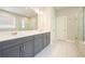 Bathroom with gray cabinets, double vanity, white countertops, tile floors, and glass shower door at 622 Denali Dr, Mableton, GA 30126