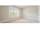 Neutral carpeted bedroom with a large window allowing for lots of light and neutral walls at 622 Denali Dr, Mableton, GA 30126