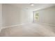 Neutral carpeted bedroom with a large window allowing for lots of light and neutral walls at 622 Denali Dr, Mableton, GA 30126