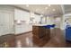 Spacious kitchen with island seating, white cabinetry, stainless steel appliances, and hardwood floors at 622 Denali Dr, Mableton, GA 30126