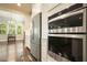 Contemporary kitchen featuring stainless steel appliances, double oven, and adjacent living area at 622 Denali Dr, Mableton, GA 30126